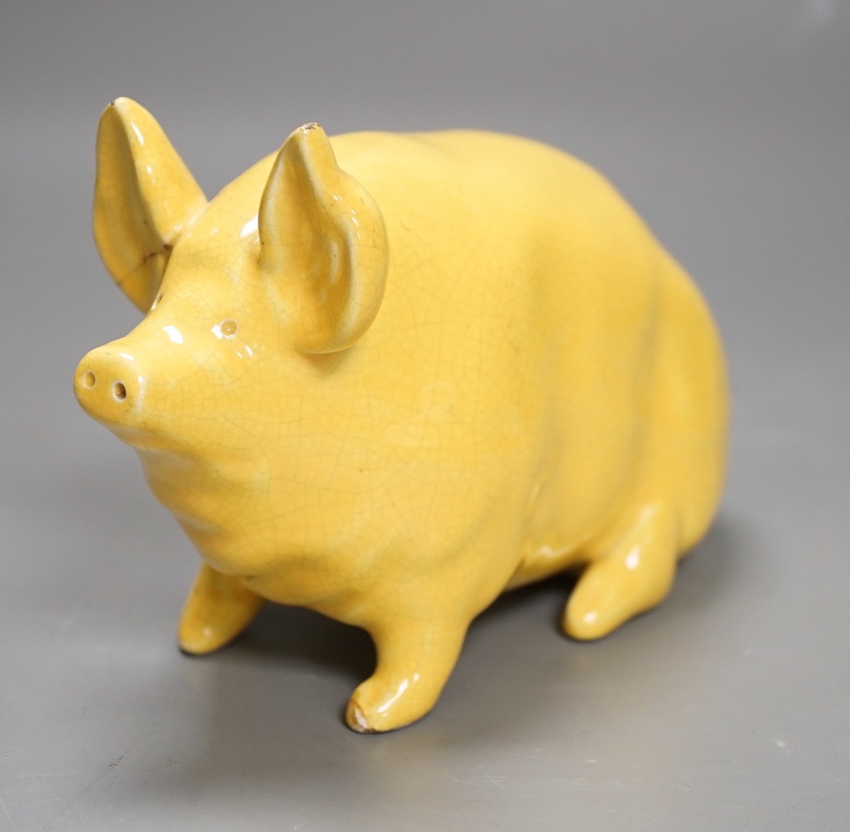 A Wemyss ware yellow glazed pig, 17cms long